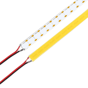 Two 24V LED strips, white PCB with +DC24V and red/black wires, yellow COB strip, diagonal on green background.