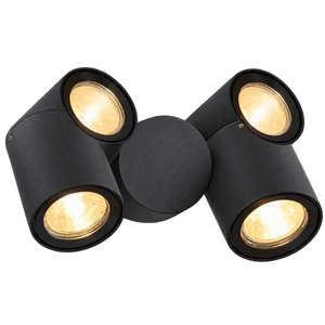 Black double adjustable outdoor spot light with two illuminated heads on a green background