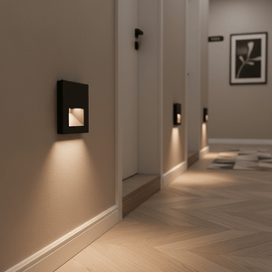 Recessed black LED step lights illuminating a hallway with warm white light, enhancing safety and style.