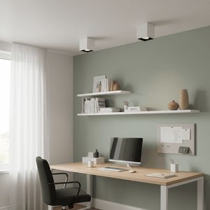 Modern office space featuring three white surface mount downlights illuminating a desk area with shelves.