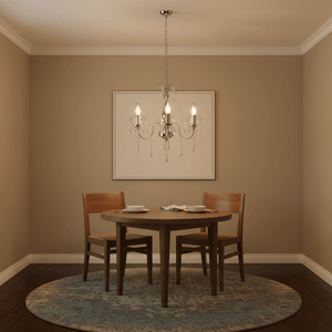 Three-arm crystal chandelier hanging above a round wooden dining table with two chairs, set in a cozy room.