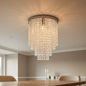 Close-up view of a chrome ceiling light fitting with K9 crystal accents, illuminating a dining area.