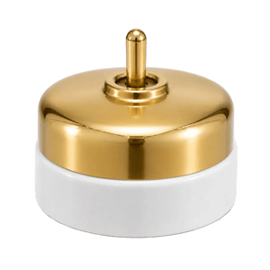 Polished gold top with a central toggle, resting on a white porcelain base.