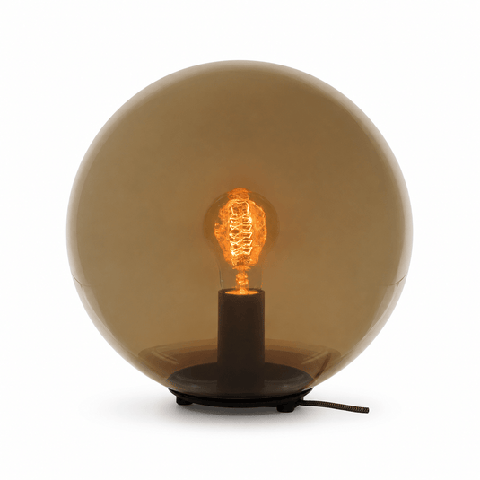 Amber PMMA orb table lamp with a black metal base and visible light bulb.