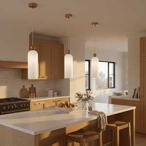 Three Antic White & Gold Pendant Lights hanging over a kitchen island with wooden cabinetry and a bowl of fruit.