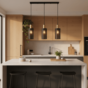 Chaluma Trio black and gold mesh pendant light hanging over a modern kitchen island with bar stools.