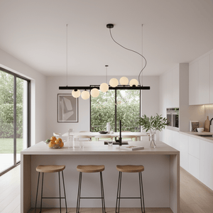 Modern kitchen featuring a Spiral 7 Light Black Pendant Light above a minimalist island with wooden stools.