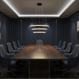 Modern black LED pendant light with crystal rings hanging above a long wooden conference table in a stylish office.