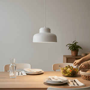white pendant light hanging above a dining table in a bright kitchen