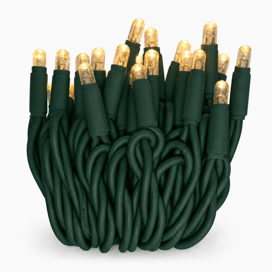 Close-up of warm white LED fairy lights on a green cable, showcasing bullet-shaped bulbs.