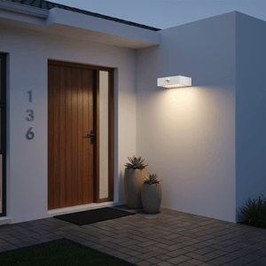 Compact solar wall light mounted beside a wooden door, illuminating the entrance area.
