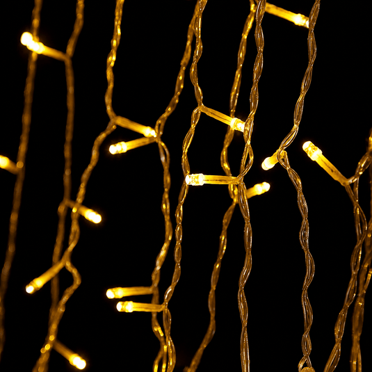 Warm white LED icicle lights arranged in a curtain style, glowing against a dark background.