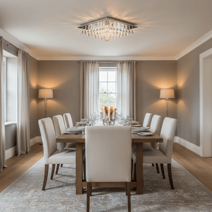 A stylish dining room featuring a large square crystal ceiling light above a wooden dining table set for a meal.