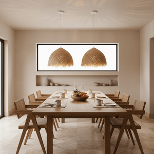 Two Feather Rattan Pendant Lights hanging above a wooden dining table set for a meal.