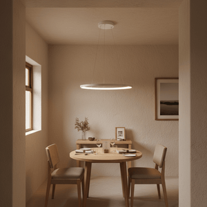 A warm white pendant light hangs above a wooden dining table set with tableware in a cozy interior.