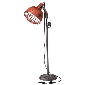 A rustic floor lamp with a red metal shade and wire cage, mounted on a decorative silver base.