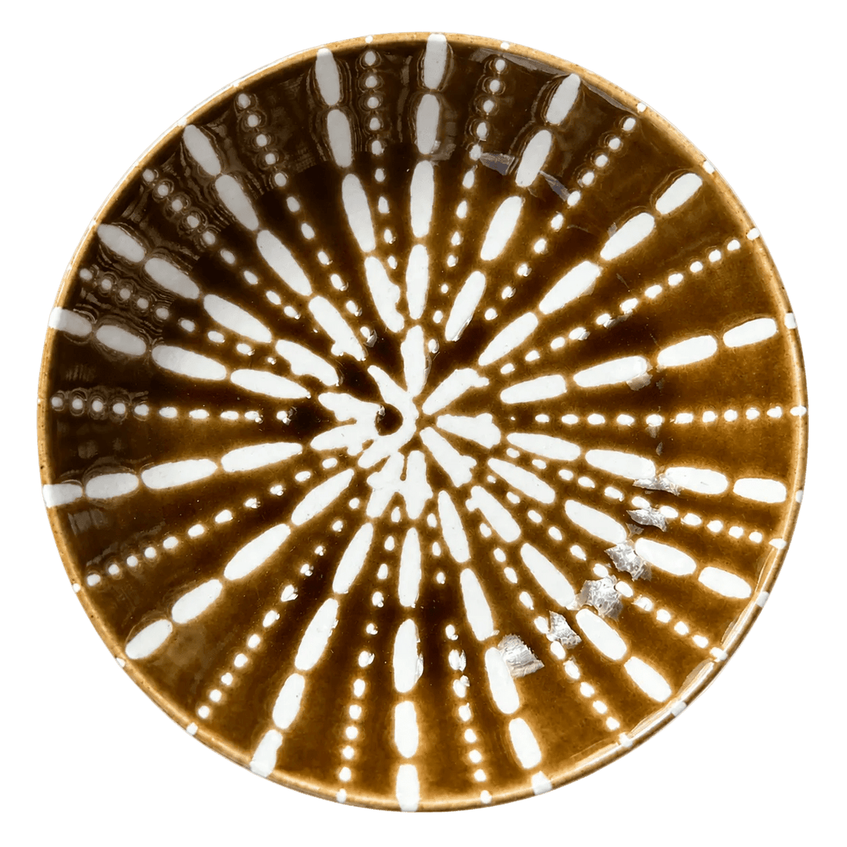 Ceramic flat bowl in burned orange with white radial patterns, featuring a glossy finish and round shape.