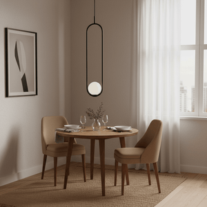 Luna Long G9 pendant light hanging above a small wooden dining table set with two chairs and decor.
