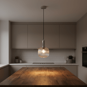 Close-up of the 40W Jackie Cut Glass Pendant light hanging over a wooden kitchen island, showcasing its textured glass