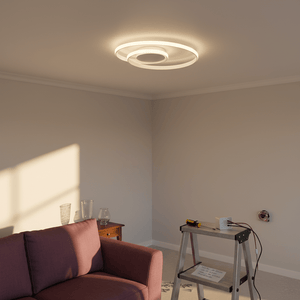 White round LED ceiling light installed in a modern living room with a pink couch and a ladder nearby.