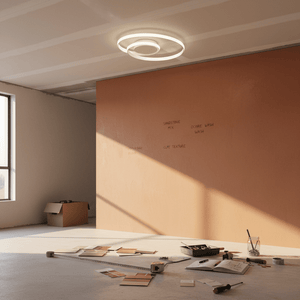 White round LED ceiling light installed in a room with a textured orange wall and scattered design materials.