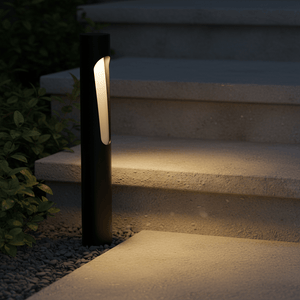 Cato LED bollard light illuminating outdoor steps, showcasing sleek black design and warm glow.