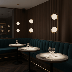 Luna Double G9 Pendant Light in a stylish restaurant setting, illuminating marble tables with a warm glow.