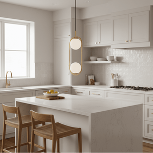 Luna Double G9 Pendant Light in gold hanging over a modern kitchen island with wooden stools.