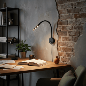 Flexible LED reading light mounted on a wall, illuminating an open book on a wooden desk.