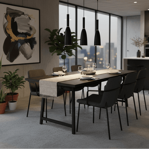Three black metal pendant lights hang above a modern dining table set for a meal, with plants and a city view.