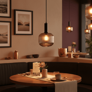 Jackie Smoke Cut Glass Pendant light hanging above a dining table with decor and menu.