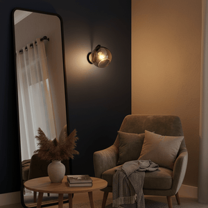 Bubble Glass Wall Light mounted beside a cozy armchair, illuminating a stylish living space with a mirror and decor.