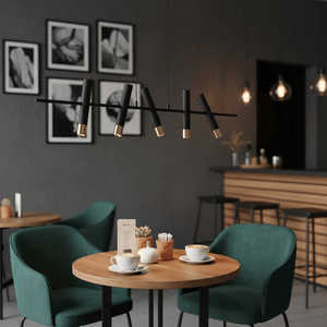 Modern 5 light LED pendant in black and gold above a cozy café table with green chairs.