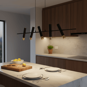 Modern 5 light LED pendant in black and gold above a kitchen island with plates and lemons.