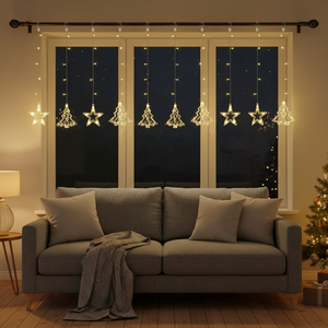 Warm white star and Christmas tree fairy curtain lights hanging in a window above a cozy sofa.