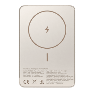 A gold Xiaomi Super Slim Magnetic Power Bank 5000 with a circular charging symbol and text on a smooth surface.