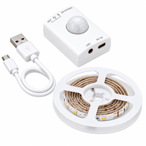 A white motion sensor control unit, a USB cable, and a roll of LED strip lights with a cool white finish.