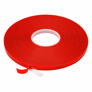 A roll of high-bond double-sided tape in bright red, with a white core, partially unrolled.