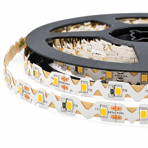 Close-up of a coiled LED striplight on a black reel, featuring a zigzag pattern with yellow and white LED lights.