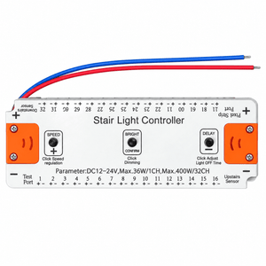 Silver rectangular stair light controller with orange buttons, blue and red wires, and printed labels on a white background.