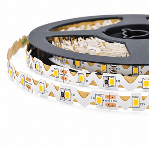 A close-up of a yellow LED strip light on a black reel, showcasing its flexible, S-shaped design and visible circuit components.
