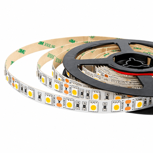 A coiled LED strip light with dark orange bulbs, mounted on a black reel, showing white backing and adhesive tape.