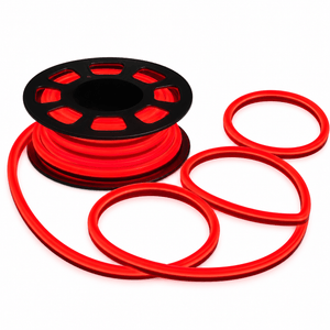 A black spool holds a coiled red neon flex strip, with additional loose loops of the same red material nearby.