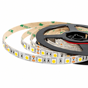 A coiled LED strip light with blue and white components, mounted on a black reel with adhesive backing.