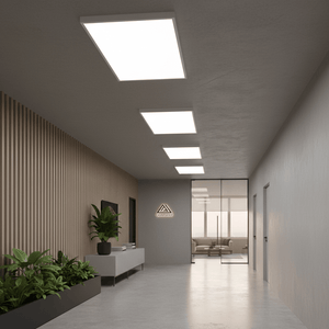 Modern office corridor featuring four LED surface-mounted backlit panels, sleek furniture, and greenery.
