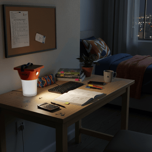 Solar LED lantern on a desk, illuminating books and a notebook, with a cozy bedroom in the background.
