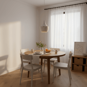 Ziggy White Wood Grain Pendant Light hanging above a round dining table set with dishes and a vase of greenery.