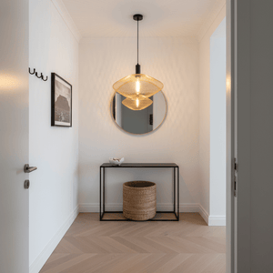 Gold mesh ceiling light hanging above a black console table with a round mirror and decorative items.