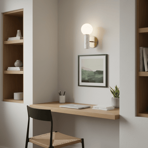 Ollie White Marble Wall Light mounted above a wooden desk in a cozy workspace, illuminating a framed artwork.