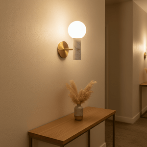 Elegant Ollie White Marble Wall Light mounted on a wall above a wooden console table with decorative vase.